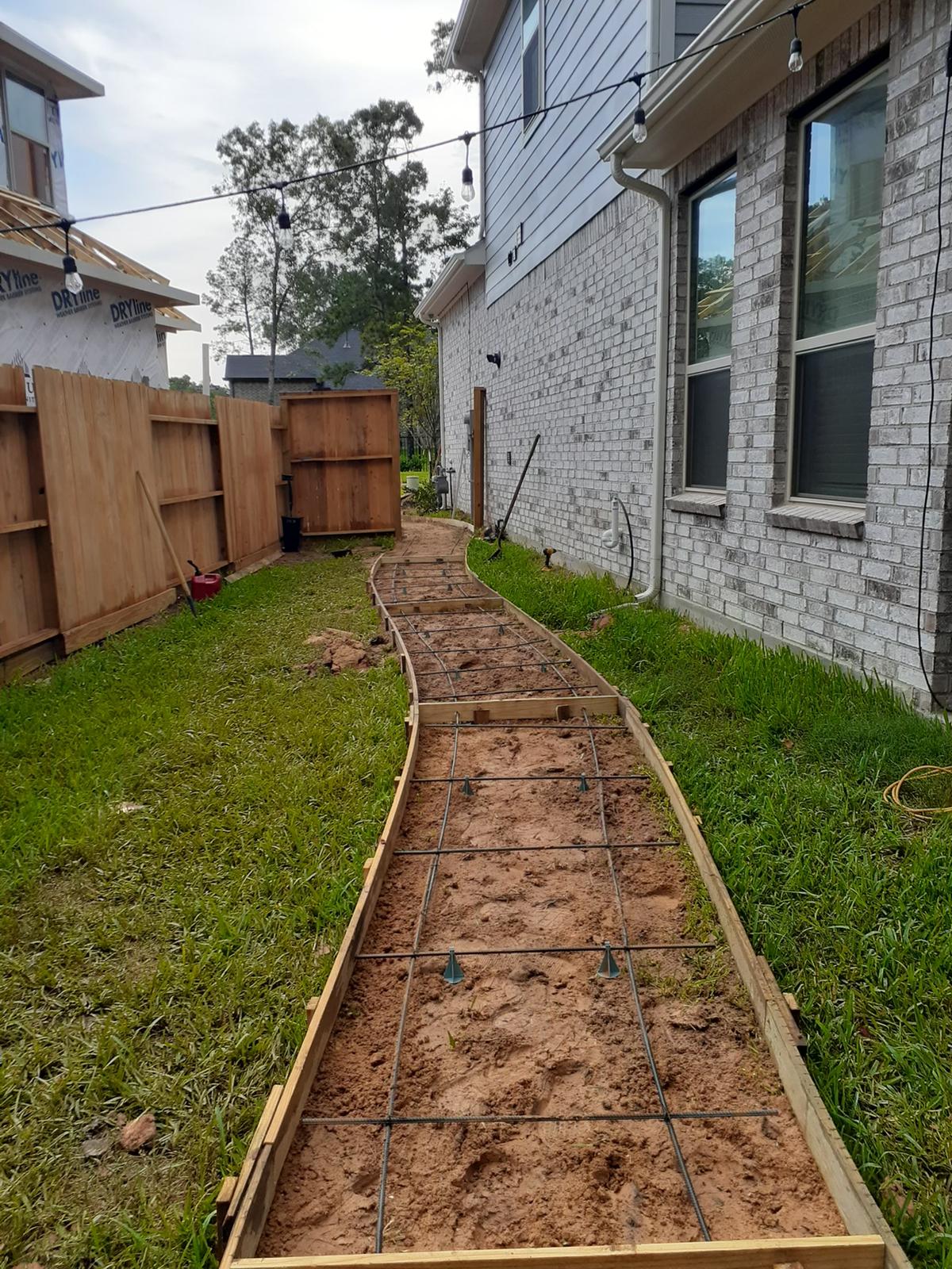 Before picture of a pathway on a backyard being built